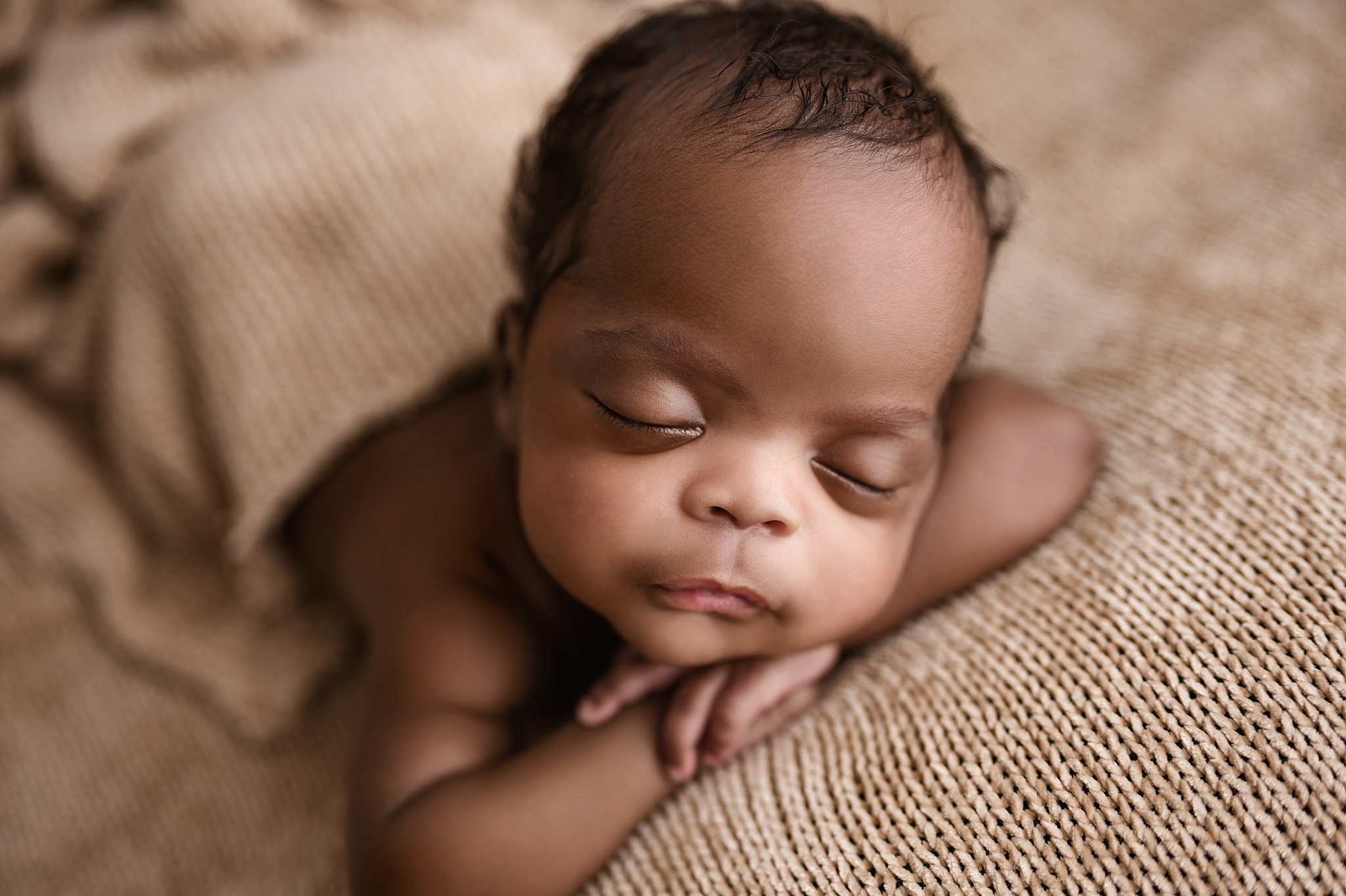 Posed newborn baby photographed in a professional newborn photography studio near Trussville, Alabama.