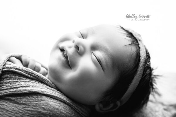 Close-up of newborn baby smile captured by a professional newborn photographer in Birmingham AL