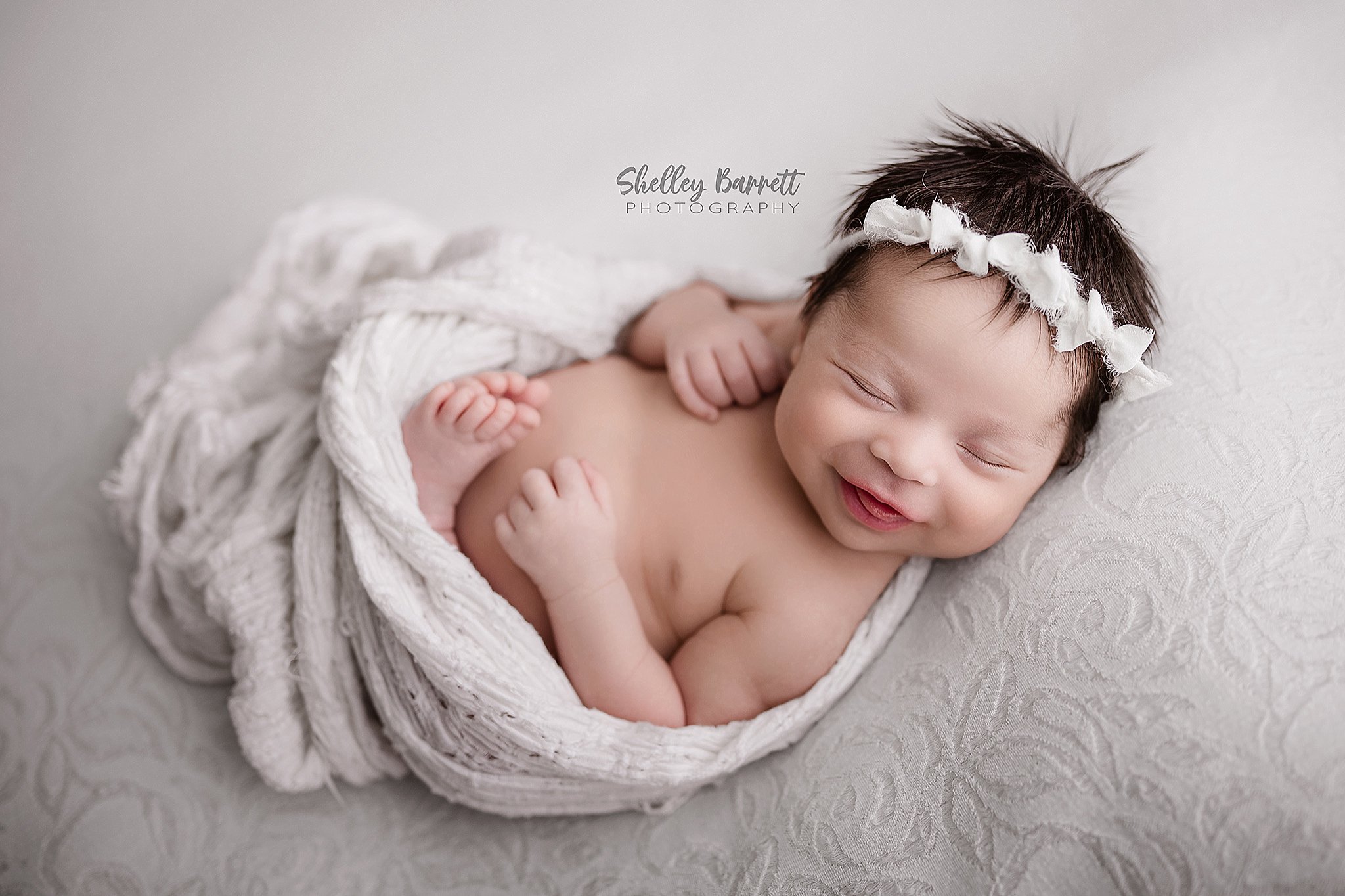 Newborn baby wrapped and sleeping in a Springville Alabama newborn photography session