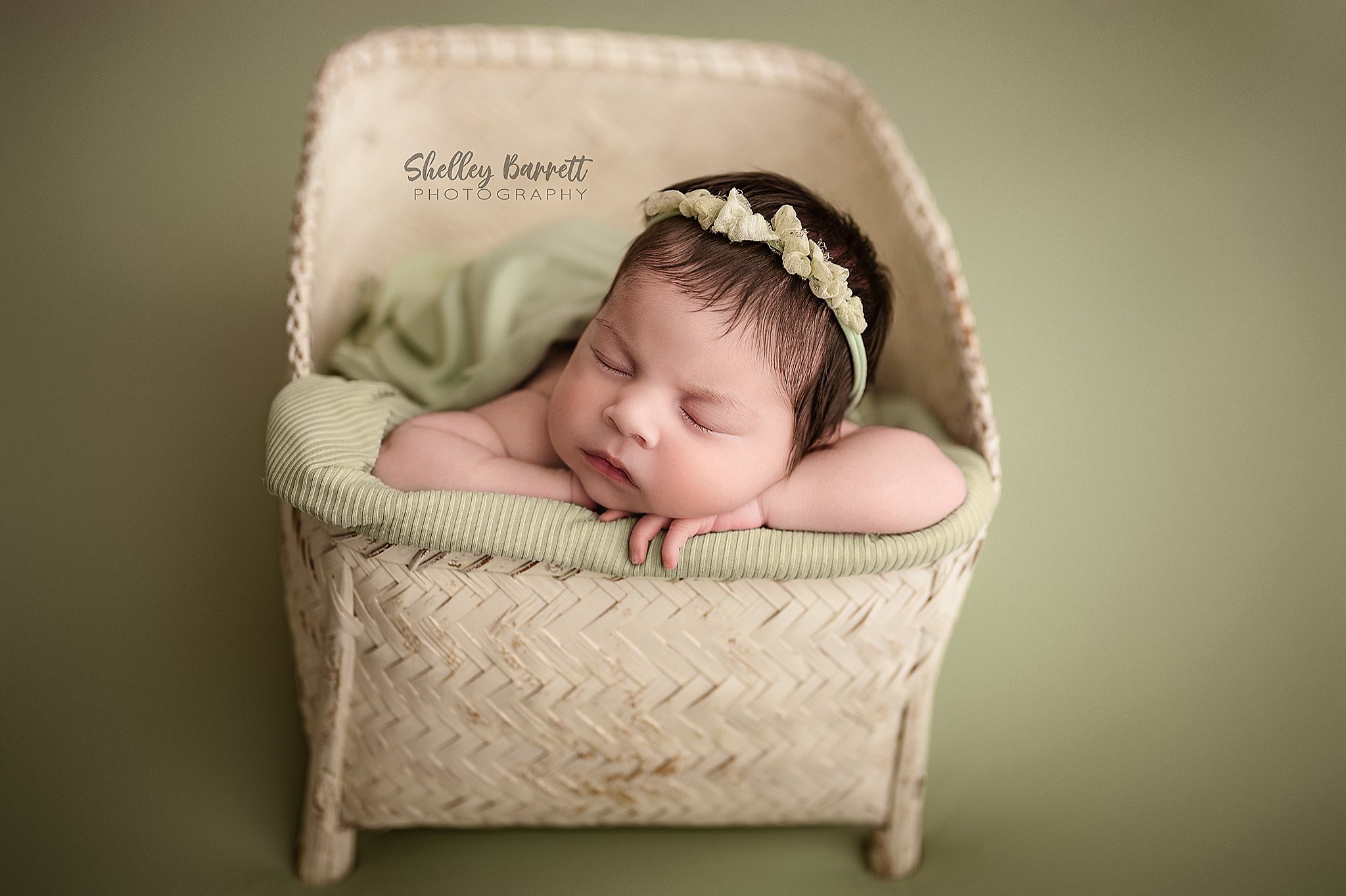 Sleeping newborn photographed in a basket by a Springville newborn photographer in Trussville, Alabama
