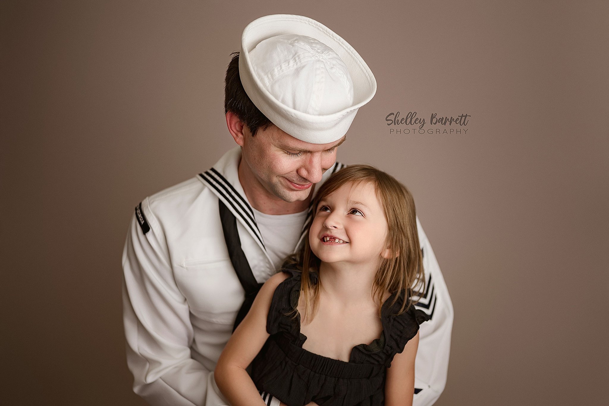 USA Sailor in uniform Father cuddling his little daughter during a Birmingham newborn photography session