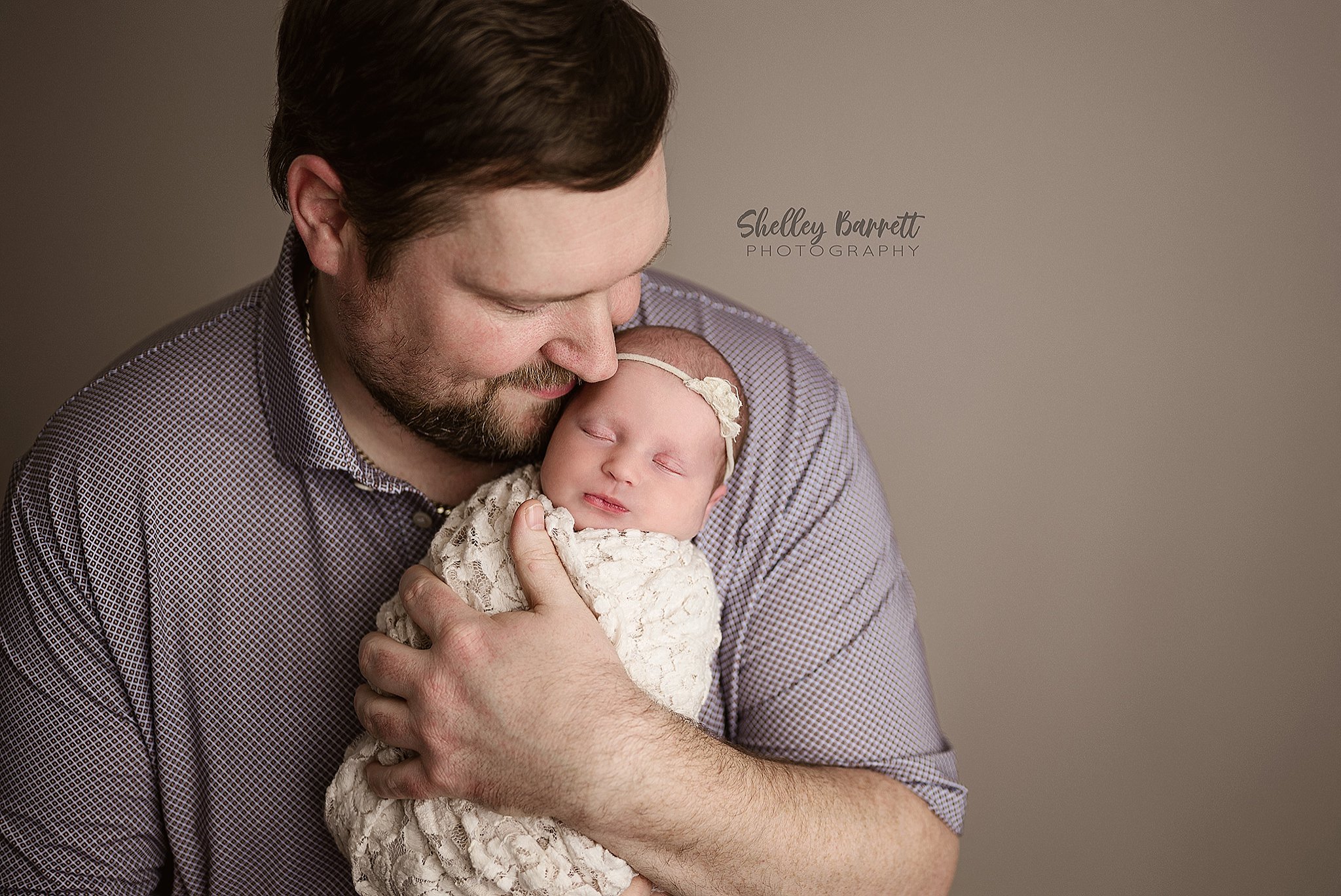 Father bonding with newborn baby during a Trussville newborn photography session