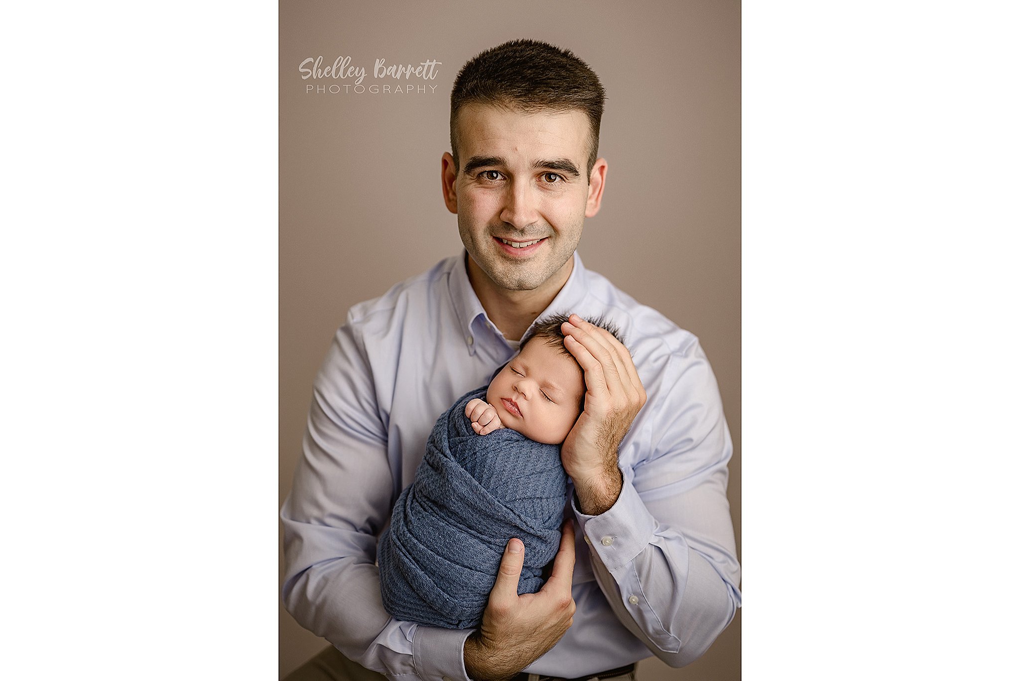 Tender father and baby moment captured by a professional newborn photographer in Alabama