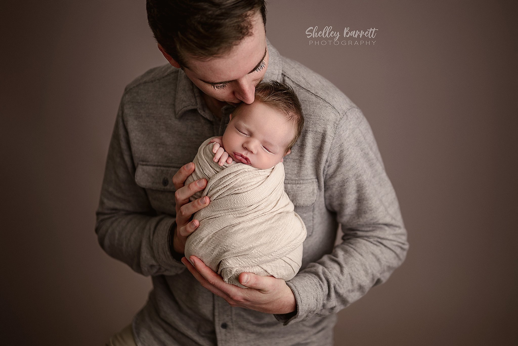 Father bonding with newborn baby during a Trussville newborn photography session